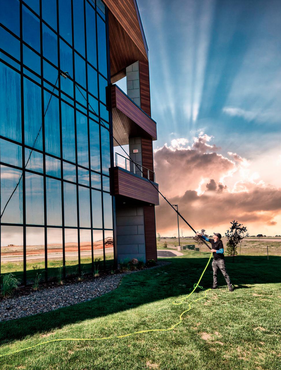 Water-fed pole cleaning on a commercial glass building in Rapid City