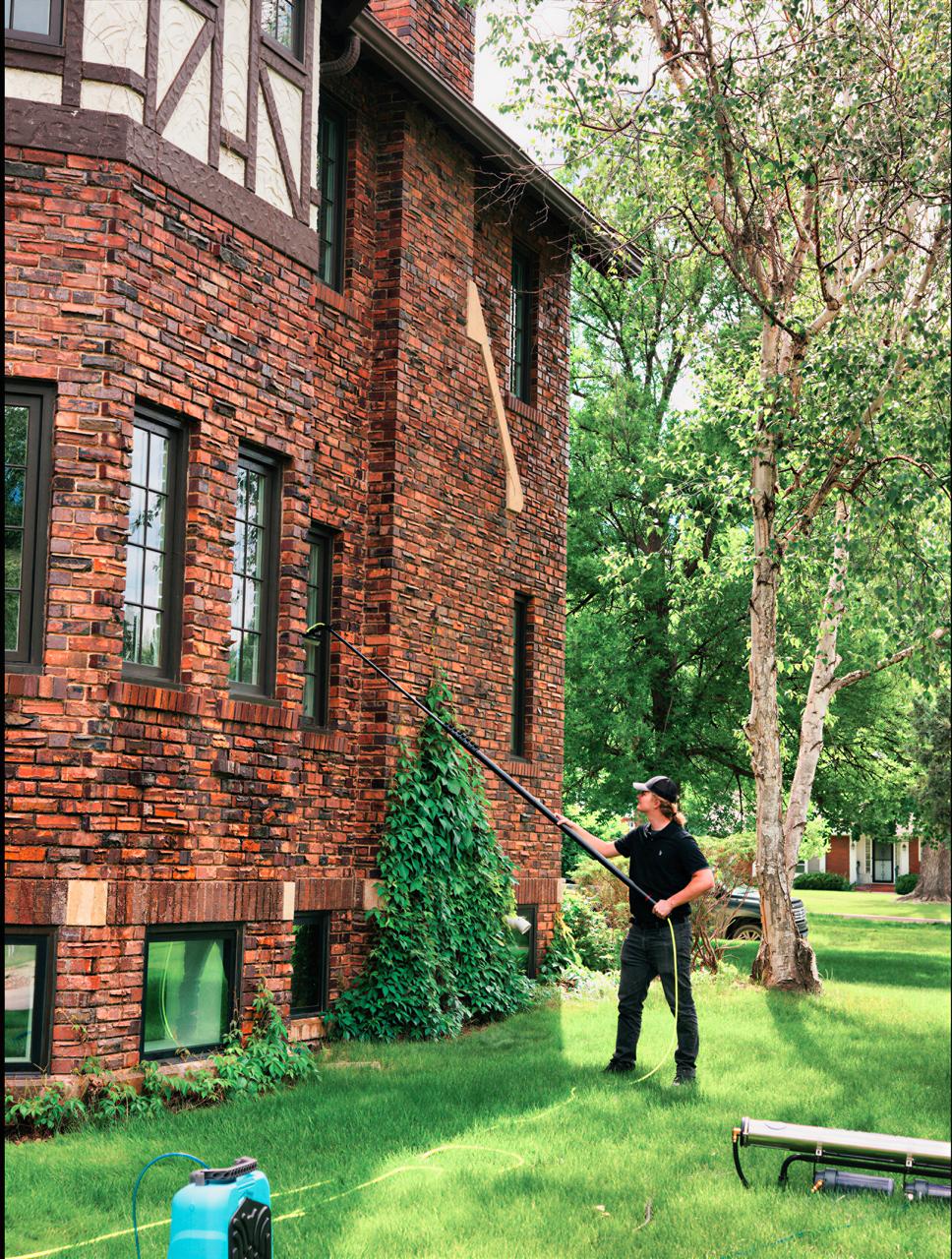 Residential windows being cleaned on a brick home